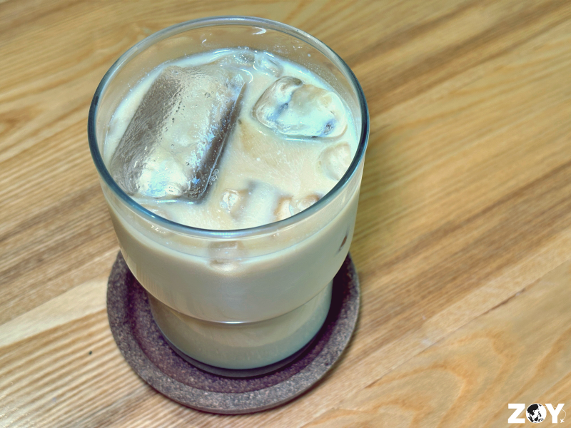 Iced latte served at 717 Coffee and Co on wooden table